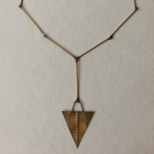 Handmade long necklace from oxidized brass. The center part is made from handtextured brass sheet and the chain is handmade from brass wire. The part that rests on the neck is from black satin cord. A lariat style totally handmade necklace ideal to make your outfit stand out.