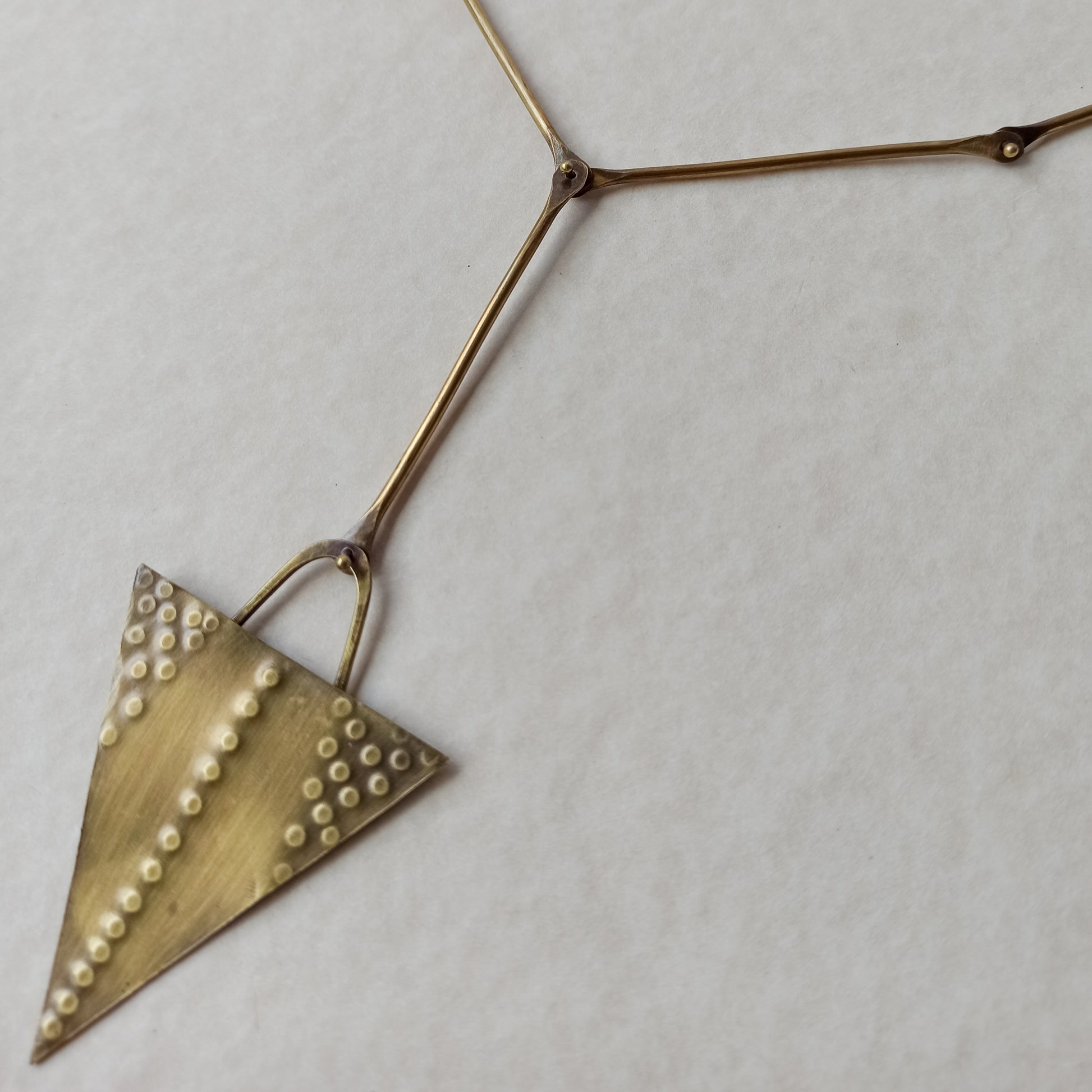 Handmade long necklace from oxidized brass. The center part is made from handtextured brass sheet and the chain is handmade from brass wire. The part that rests on the neck is from black satin cord. A lariat style totally handmade necklace ideal to make your outfit stand out.