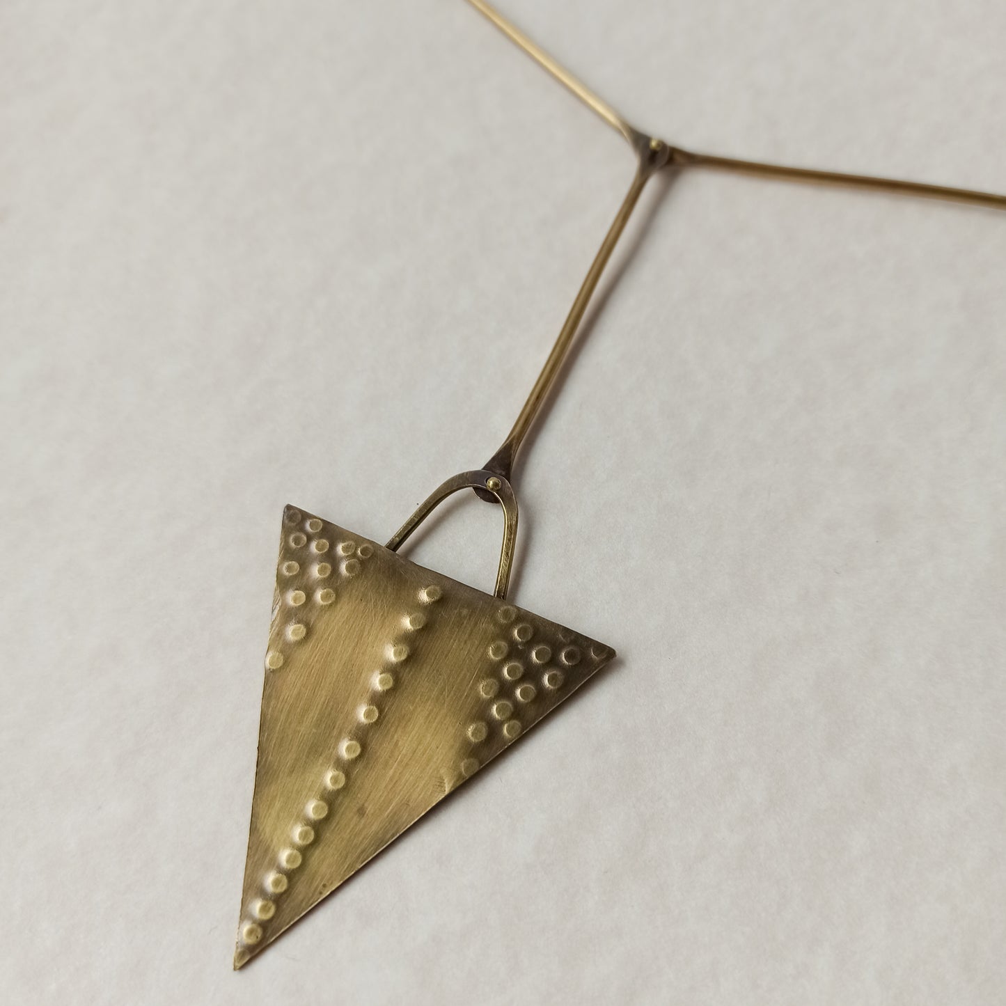 Handmade long necklace from oxidized brass. The center part is made from handtextured brass sheet and the chain is handmade from brass wire. The part that rests on the neck is from black satin cord. A lariat style totally handmade necklace ideal to make your outfit stand out.