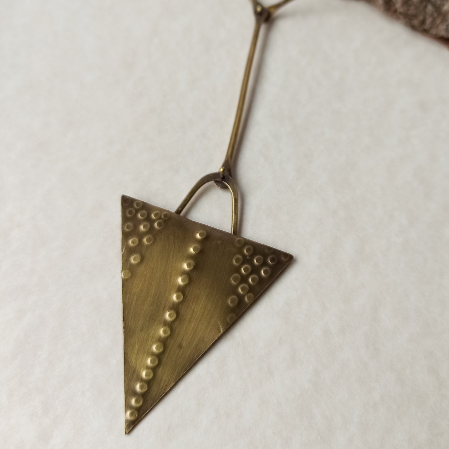 Handmade long necklace from oxidized brass. The center part is made from handtextured brass sheet and the chain is handmade from brass wire. The part that rests on the neck is from black satin cord. A lariat style totally handmade necklace ideal to make your outfit stand out.