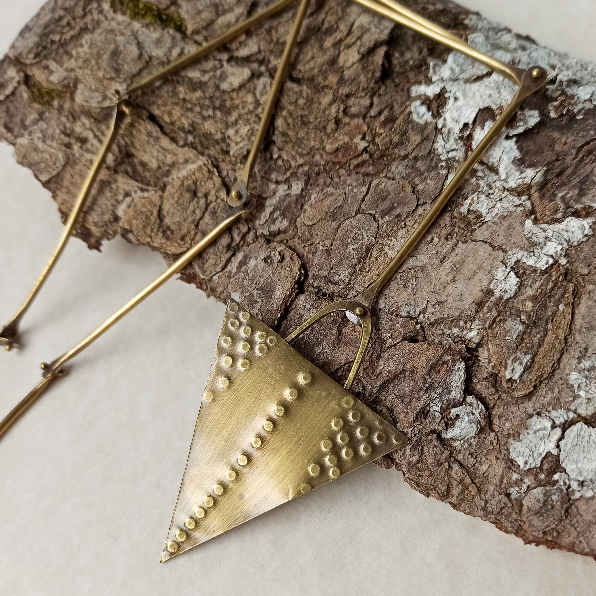 Handmade long necklace from oxidized brass. The center part is made from handtextured brass sheet and the chain is handmade from brass wire. The part that rests on the neck is from black satin cord. A lariat style totally handmade necklace ideal to make your outfit stand out.