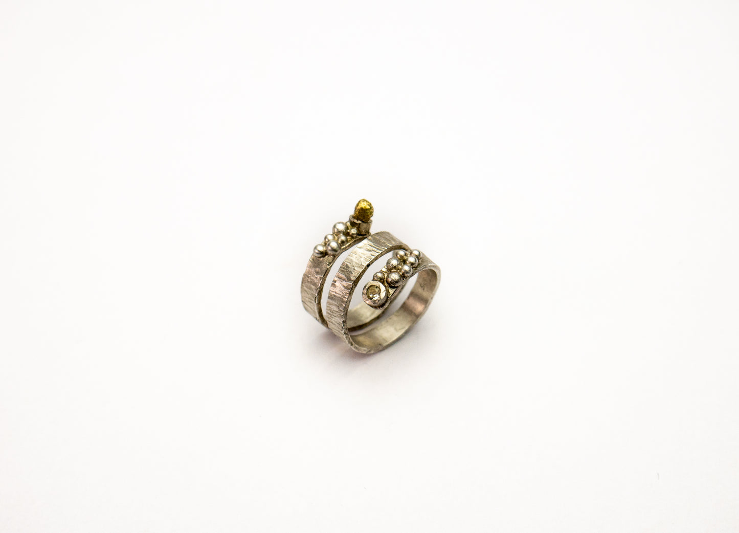 Statement sterling silver wraparound ring with silver granules and swarovski crystal.