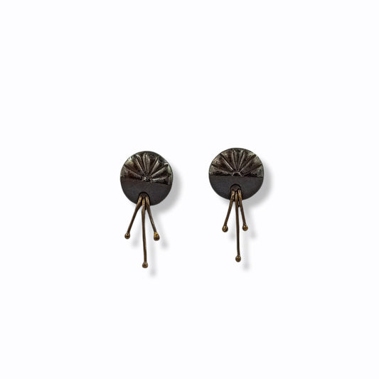 Handmade stud earrings from black porcelain with brass wires that hangs