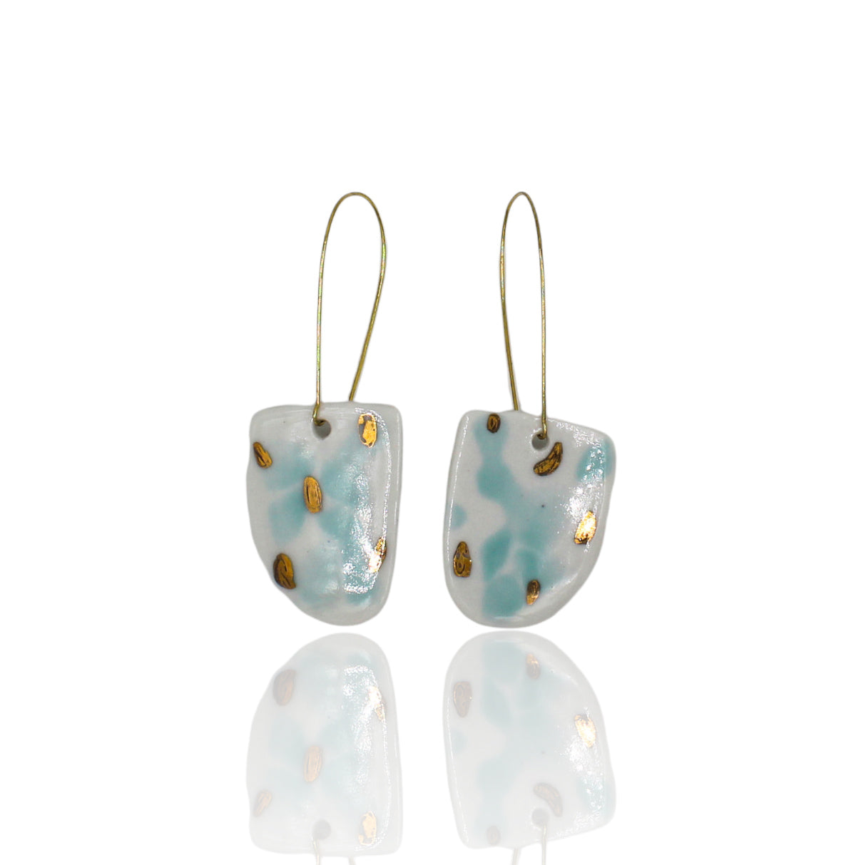 White porcelain drop earrings with aquamarine  and gold luster spots. Hanging from long gold plated  earhooks.