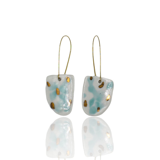 White porcelain drop earrings with aquamarine  and gold luster spots. Hanging from long gold plated  earhooks.